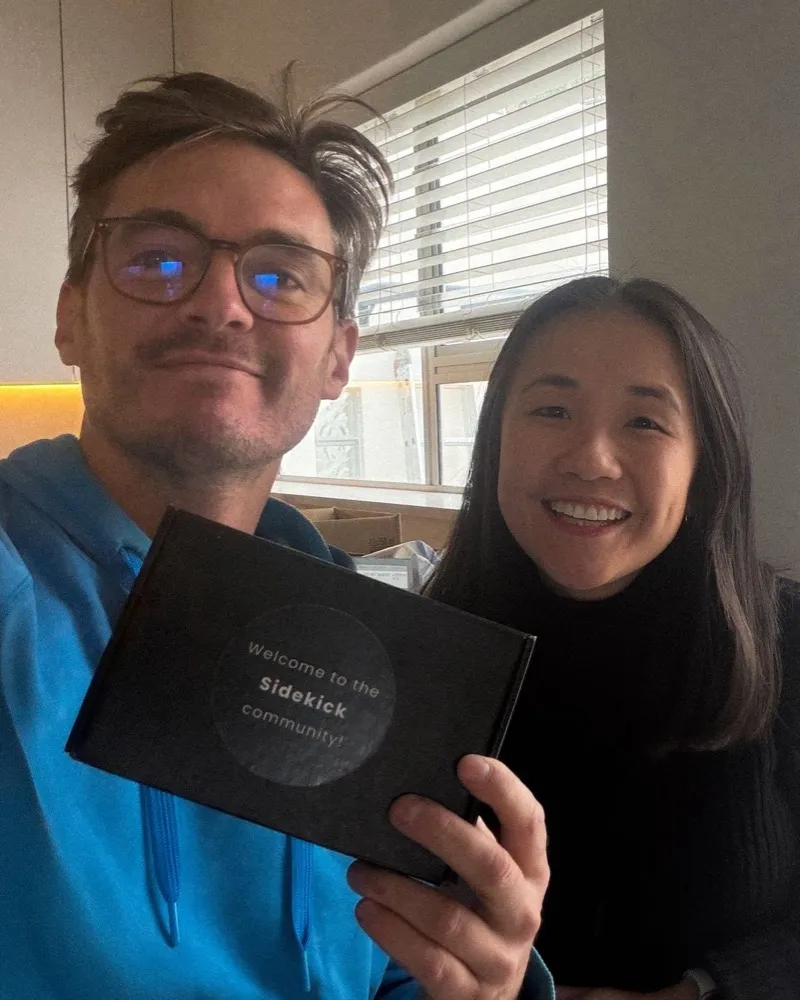 A client and his Sidekick smiling with a “Welcome to the Sidekick community!” box