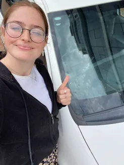 Tate giving a thumbs up next to the freshly serviced car